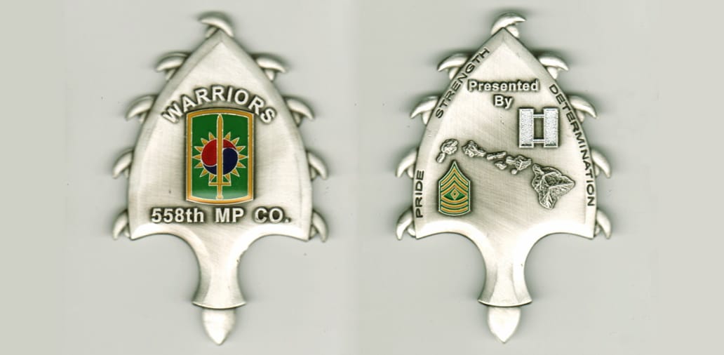 Arrowhead shaped, pewter colored coin, 3 1/4  inches high x 2  inches wide