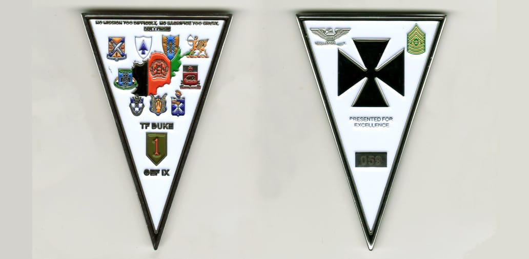 Inverted triangle shaped, silver colored coin, 2 1/2  inches high x 2 1/2  inches wide