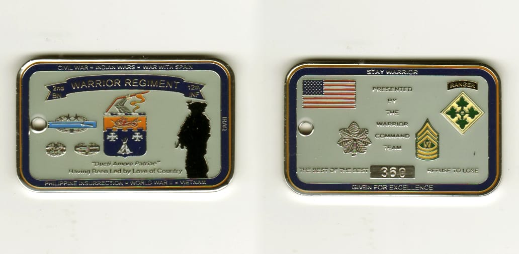 Dog tag  shaped, silver colored coin, 1 1/2 inches high x 2 1/2  inches wide