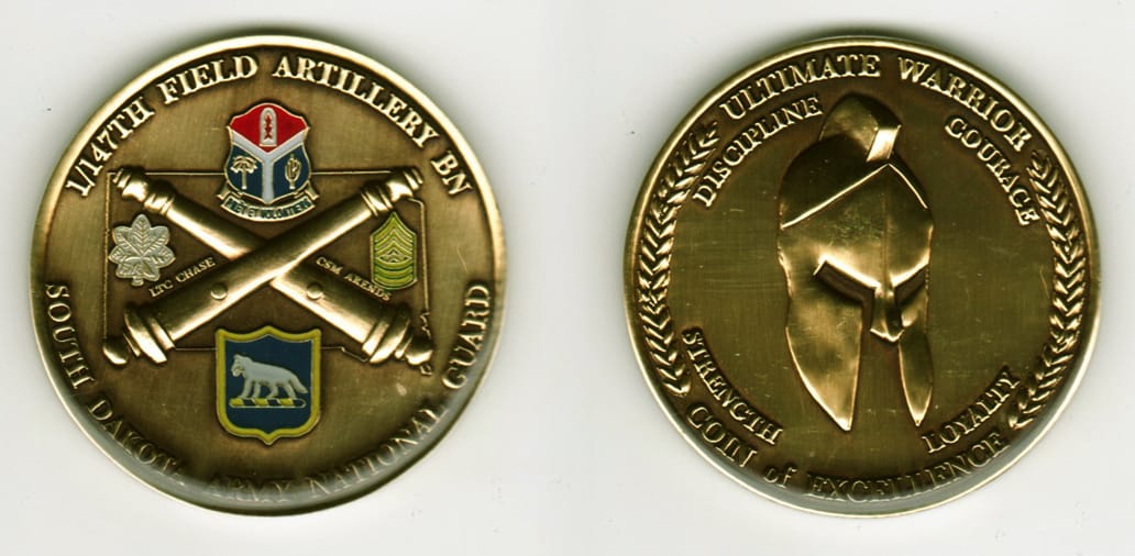 Round shaped, brass colored coin, 2 1/8 inches in diameter.