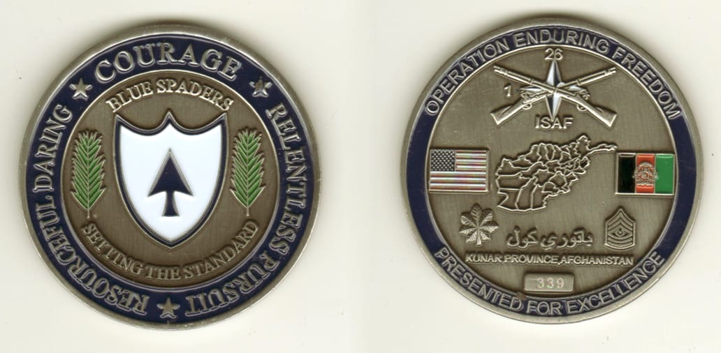 Round shaped, pewter colored coin, 2 1/8  inches in diameter.