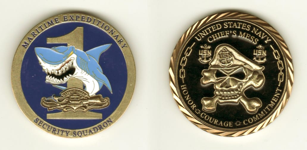 Round shaped, brass colored coin, 1 11/16 inches in diameter.