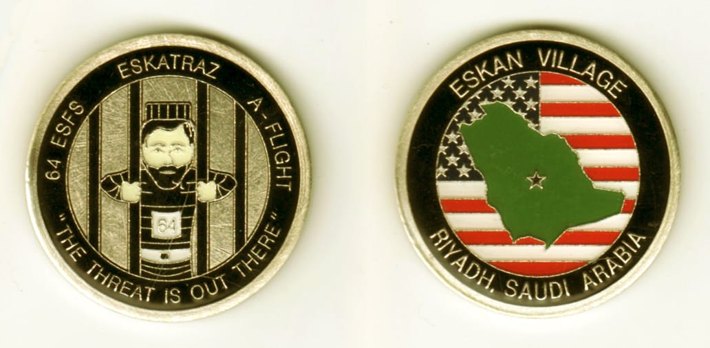 Round shaped, brass colored coin, 1 11/16 inches in diameter.