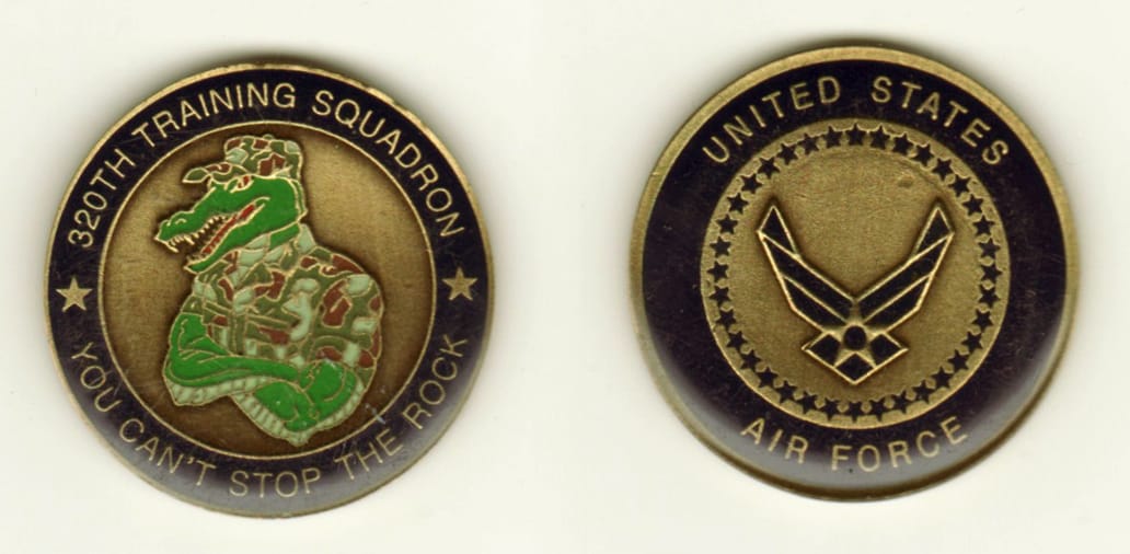 Round shaped, brass colored coin, 1 1/2 inches in diameter.