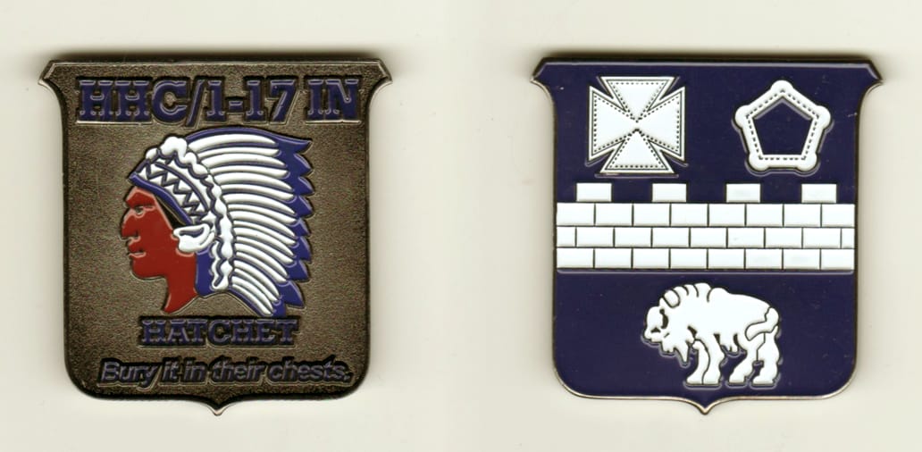 Shield shaped, pewter colored coin, 2 7/8 inches high x 2 inches wide.