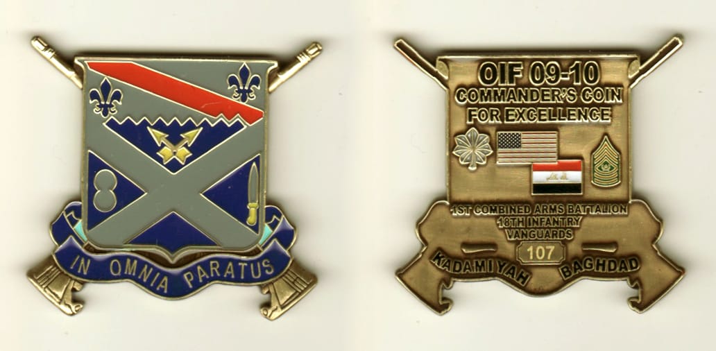 Shield shaped with crossed rifles extending, brass colored coin, 2 inches high x 1 1/2 inches wide.