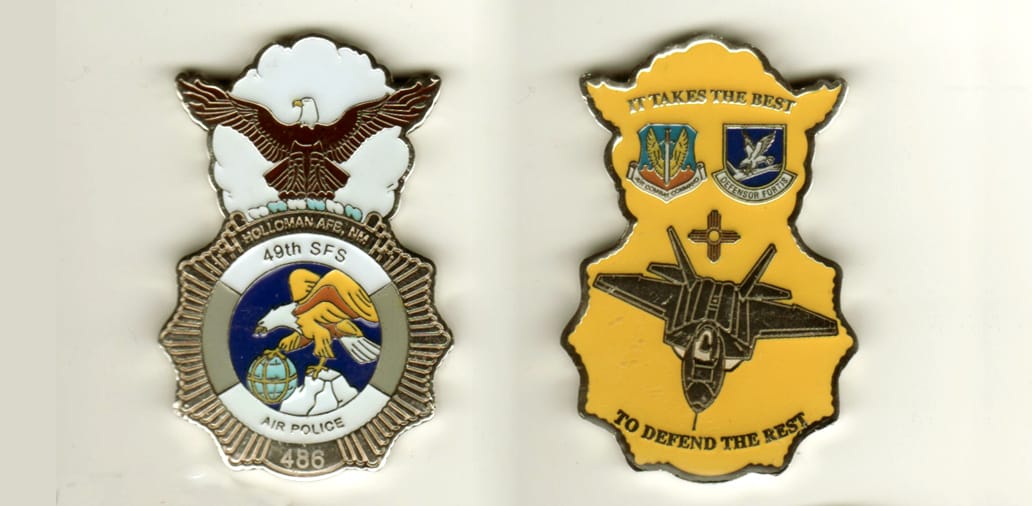 Badge shaped with circle mounted above with eagles outstreatched wings extending, silver colored coin, 2 3/16 inches hig...