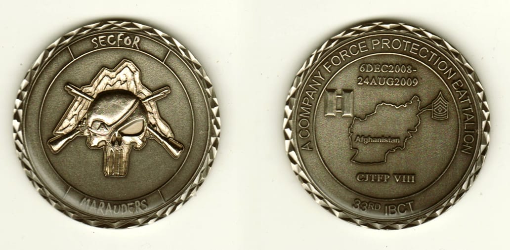 Round shaped, pewter colored coin, 2 inches in diameter.