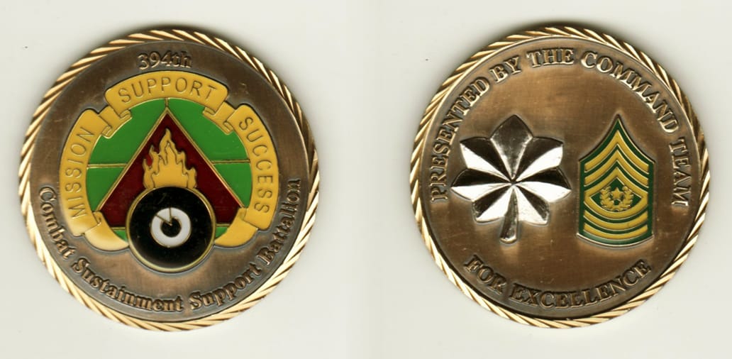 Round shaped, brass colored coin with pewter rim, 2 inches in diameter.