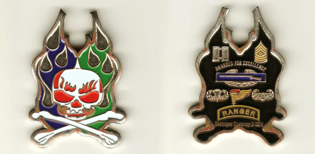 Flame shaped, silver colored coin, 2 inches high x 1 1/2 inches wide.