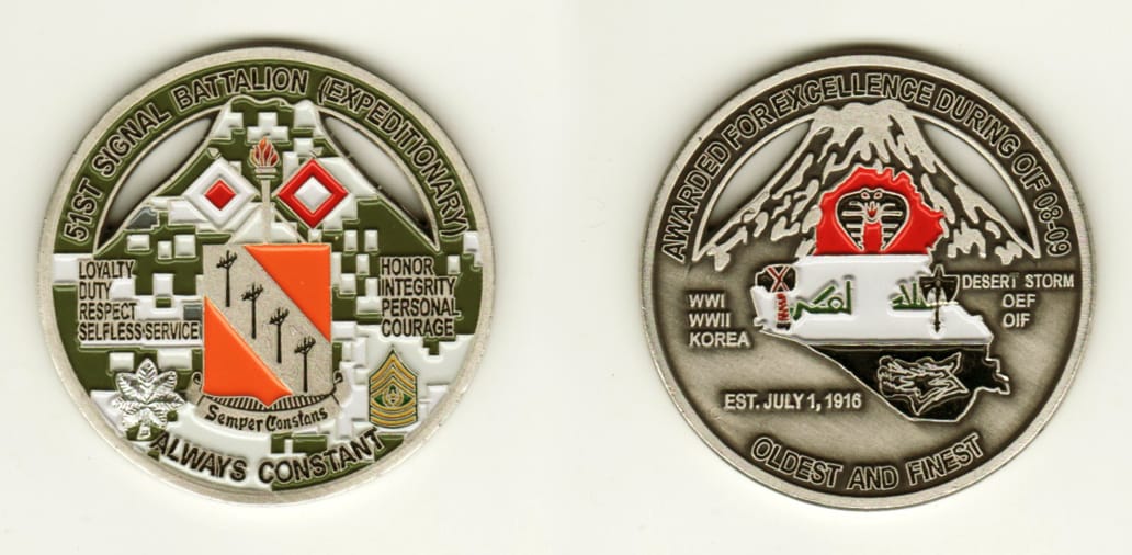 Round shaped, pewter colored coin, 2 inches in diameter.