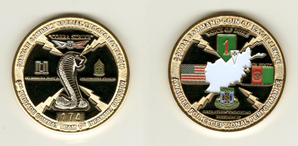 Round shaped, gold colored coin, 1 11/16 inches in diameter.