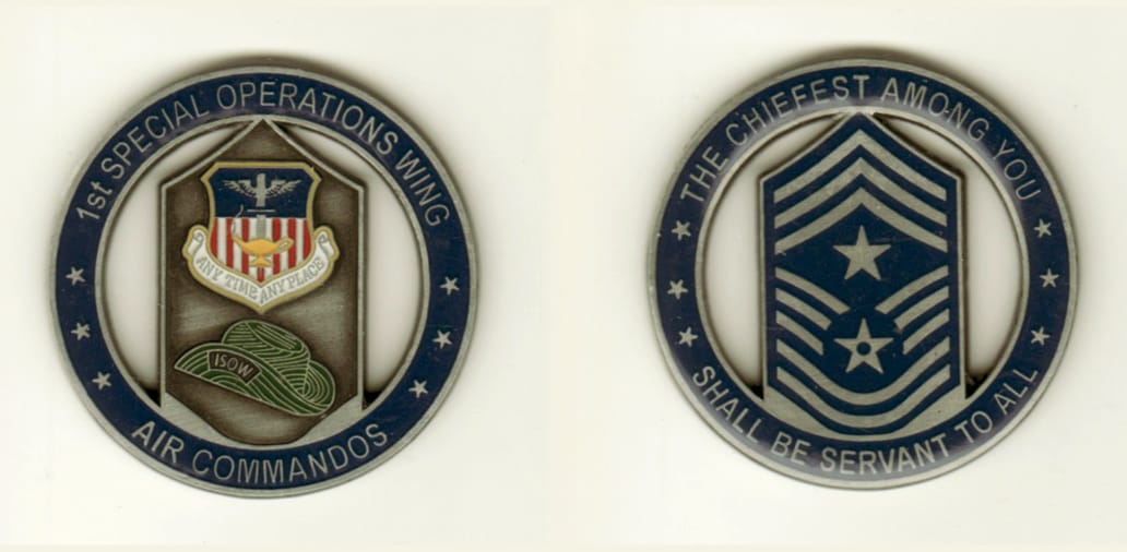 Round shaped, pewter colored coin, 1 11/16 inches in diameter.