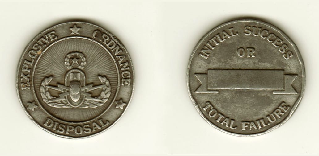 Round shaped, pewterr colored coin, 1 11/16 inches in diameter.