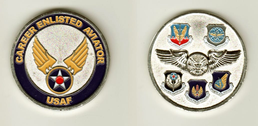 Round shaped, silver colored coin, 1 1/2 inches in diameter.