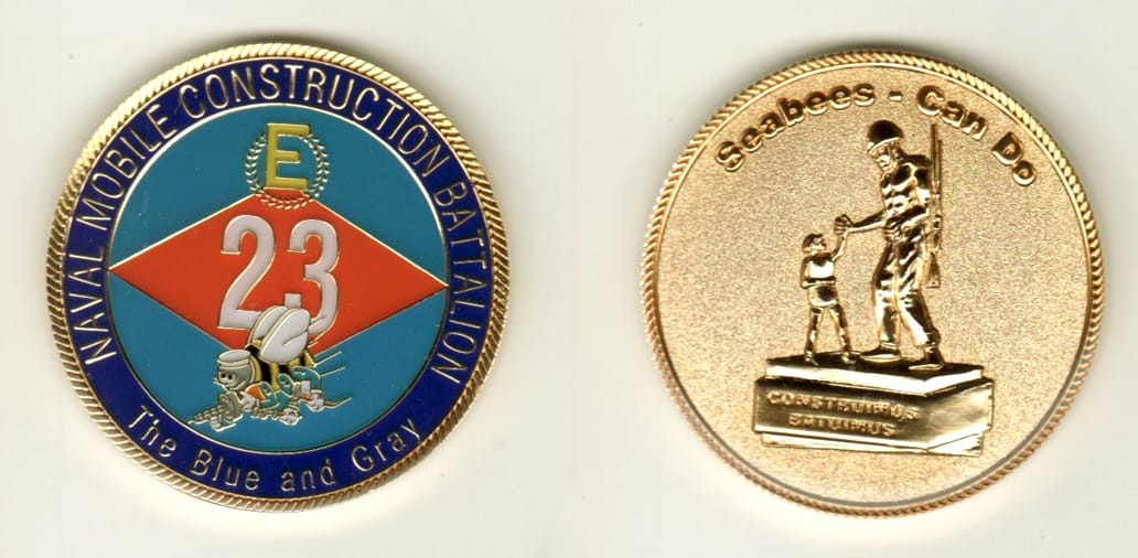 Round shaped, gold colored coin, 1 11/16 inches in diameter.