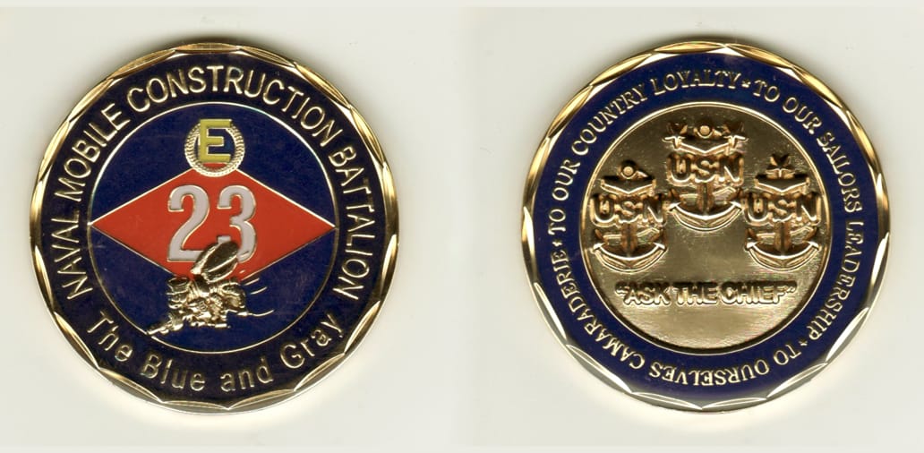 Round gold, brass colored coin, 2 inches in diameter.