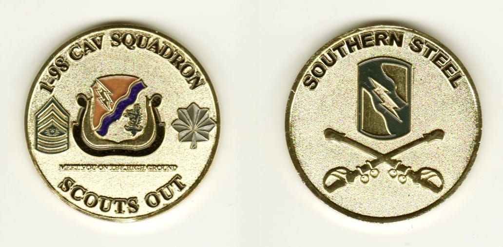 Round shaped, gold colored coin, 1 11/16 inches in diameter.