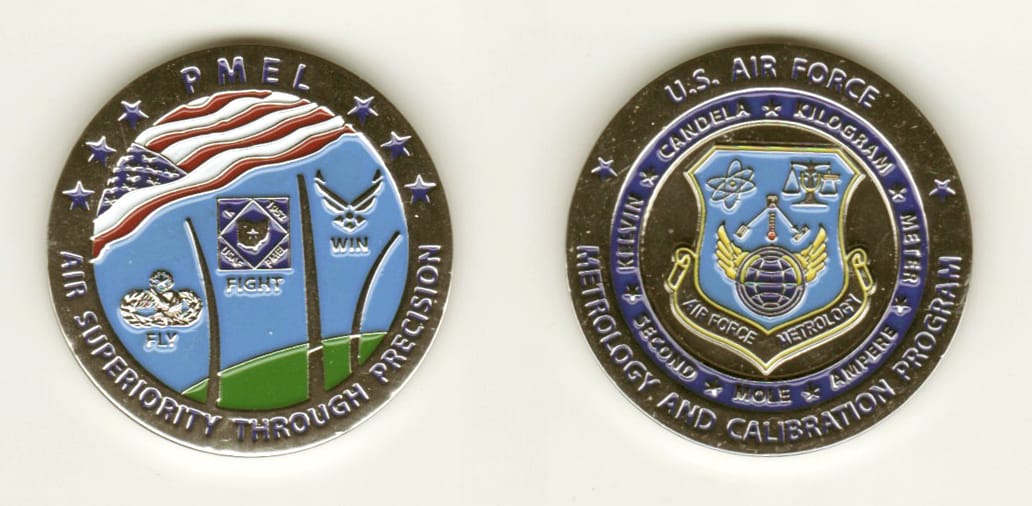 Round shaped, silver colored coin, 1 1/4 inches in diameter.