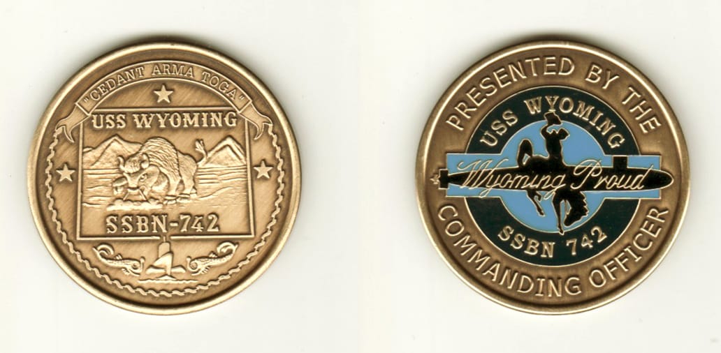 Round shaped, brass colored coin, 1 1/4 inches in diameter.