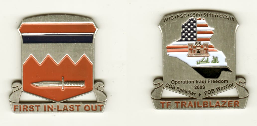 Shield shaped with banner mounted beneath, silver colored coin, 1 3/4 inches high x 1 3/4 inches wide.