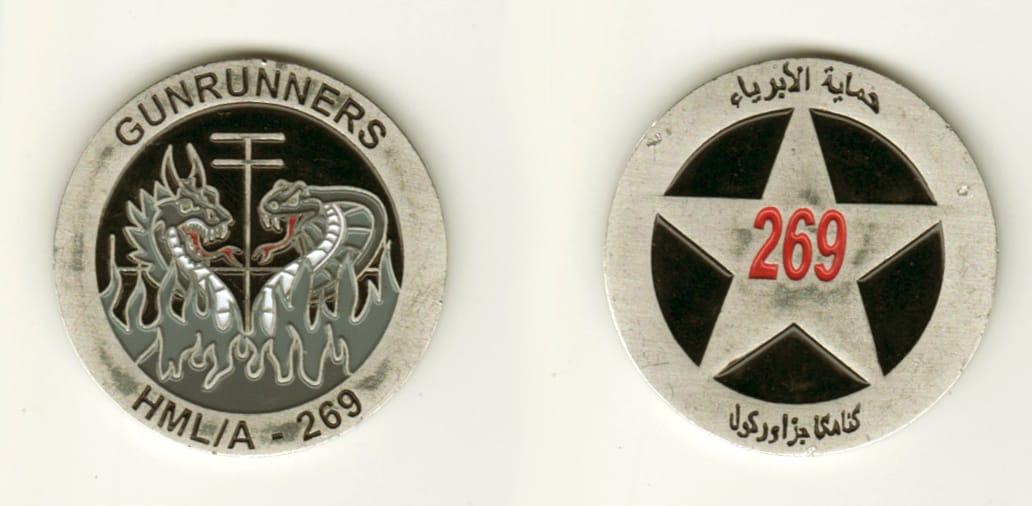 Round shaped, silver colored coin, 1 1/2 inches in diameter.