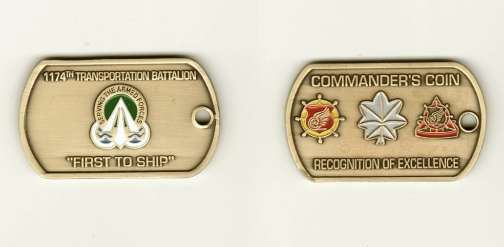 Dog Tag shaped, brass colored coin, 1 inch high x 1 3/4 inches wide.