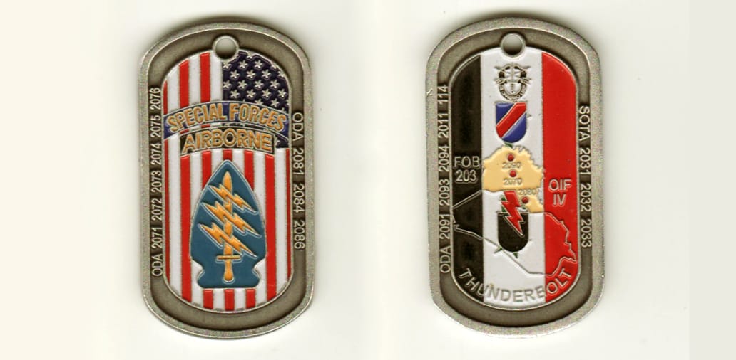 Dog Tag shaped, brass colored coin, 1 3/4 inches high x  3/4 inch wide.