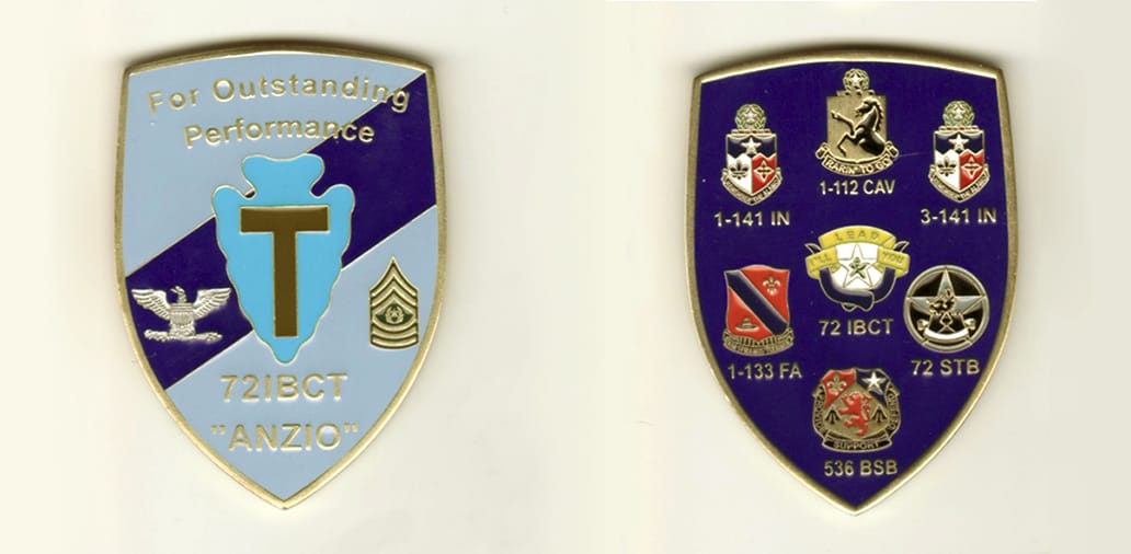 Shield shaped, brass colored coin, 2 1/2  inches high x 1 1/2 inches wide.