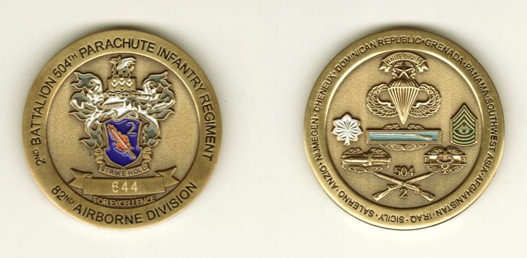 Round shaped, brass colored coin, 1 11/16 inches in diameter.