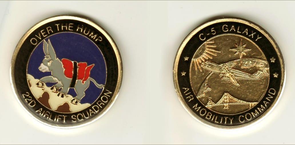 Round shaped, gold colored coin, 1 11/16 inches in diameter.