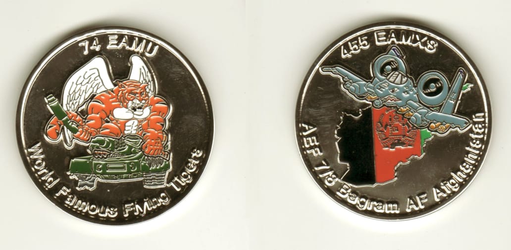 Round shaped, silver colored coin, 1 11/16 inches in diameter.