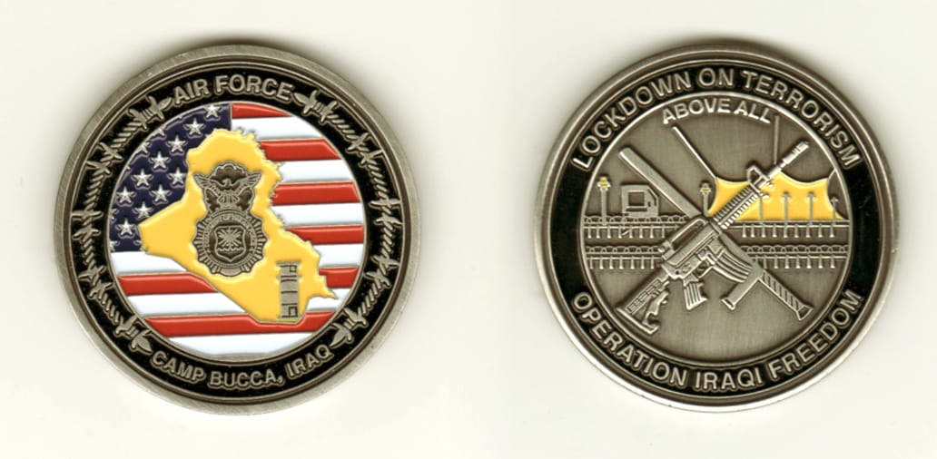 Round shaped, pewter colored coin, 1 11/16 inches in diameter.