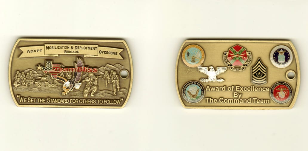 Dog Tag shaped, brass colored coin, 1 1/2 inch high x 2 2/4 inches wide.