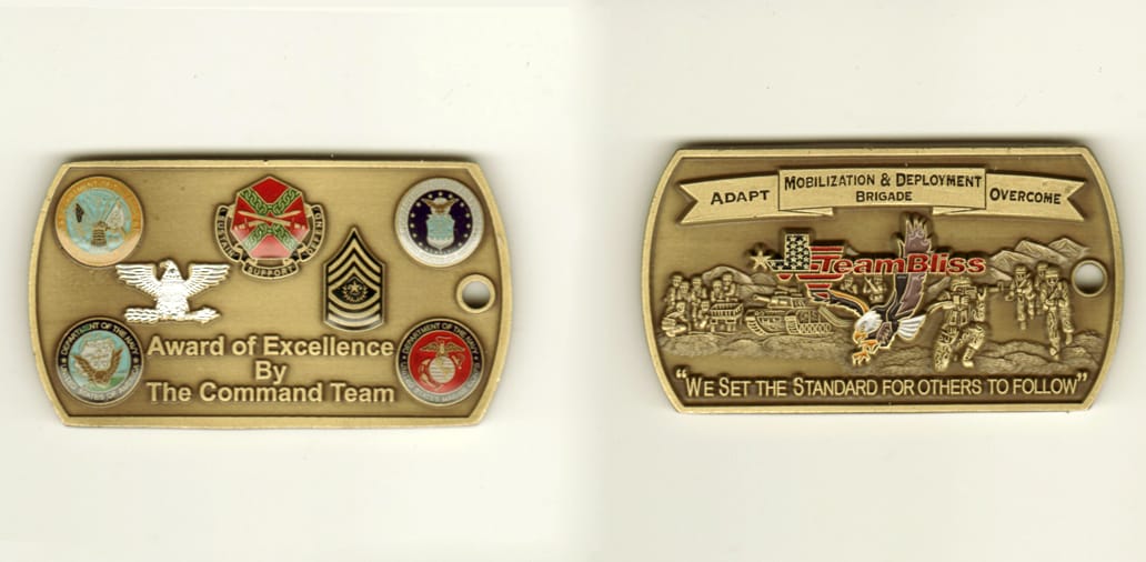 Dog Tag shaped, brass colored coin, 1 1/2 inch high x 2 2/4 inches wide.