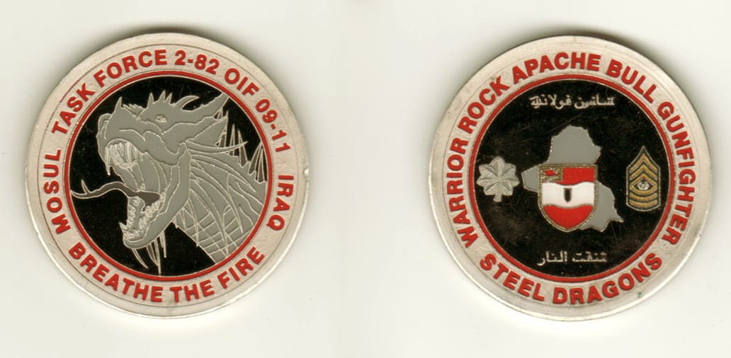 Round shaped, pewter colored coin, 2 inches in diameter.