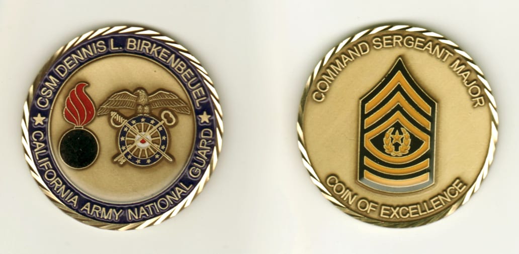 Round shaped, gold colored coin, 2 1/8 inches in diameter.