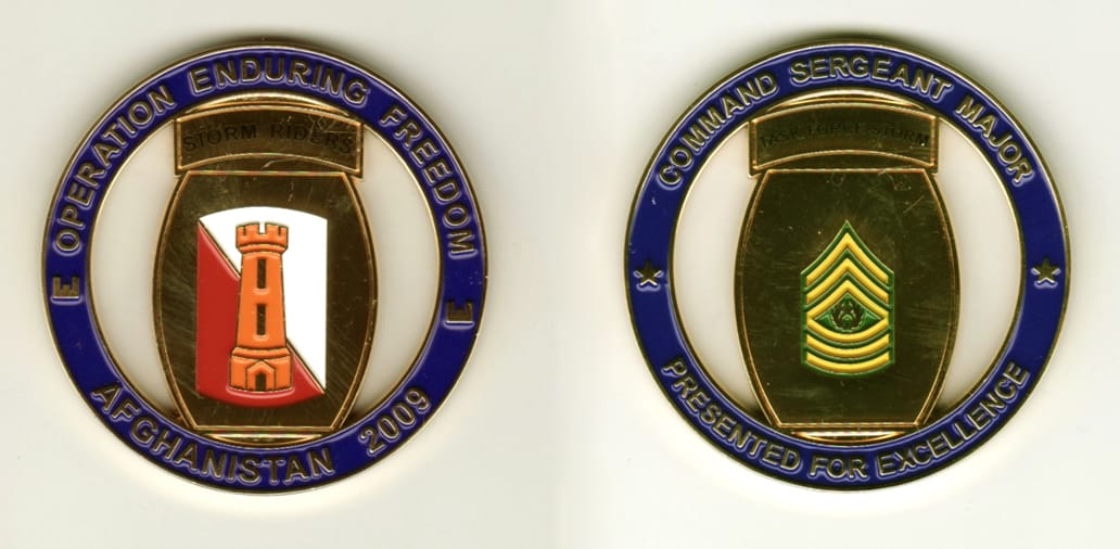 Round shaped, gold colored coin, 2 1/8 inches in diameter.