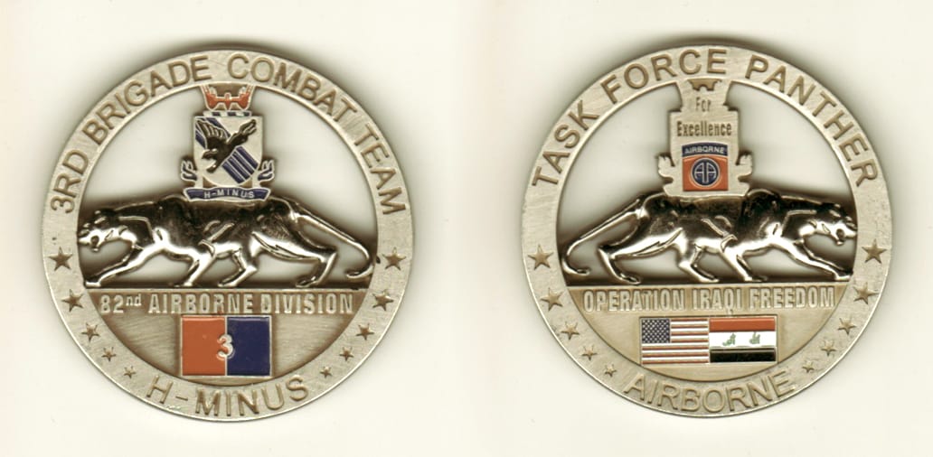 Round shaped, pewter colored coin, 2 inches in diameter.