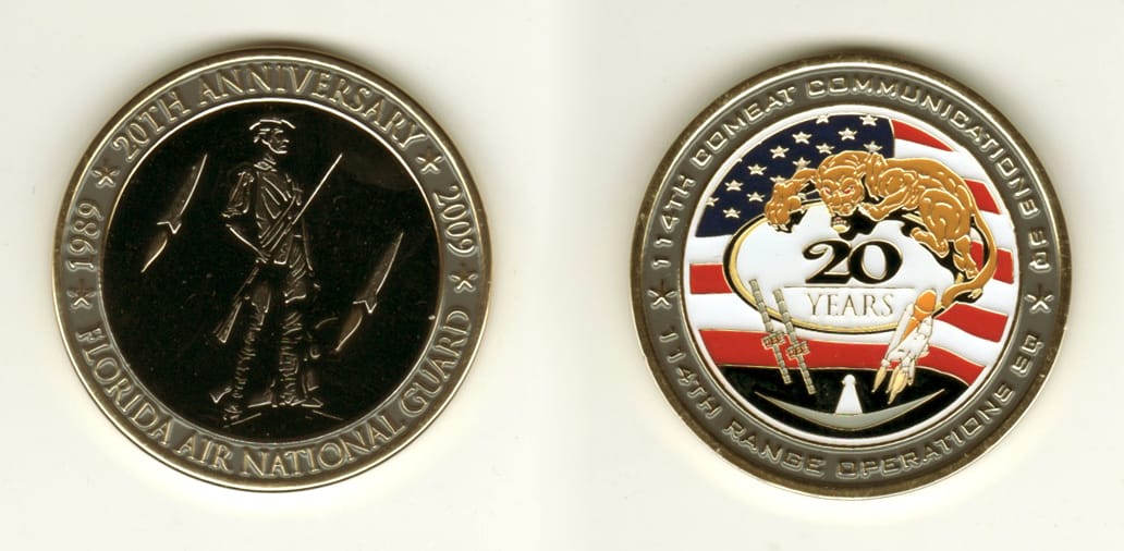 Round shaped, gold colored coin, 2 1/8 inches in diameter.