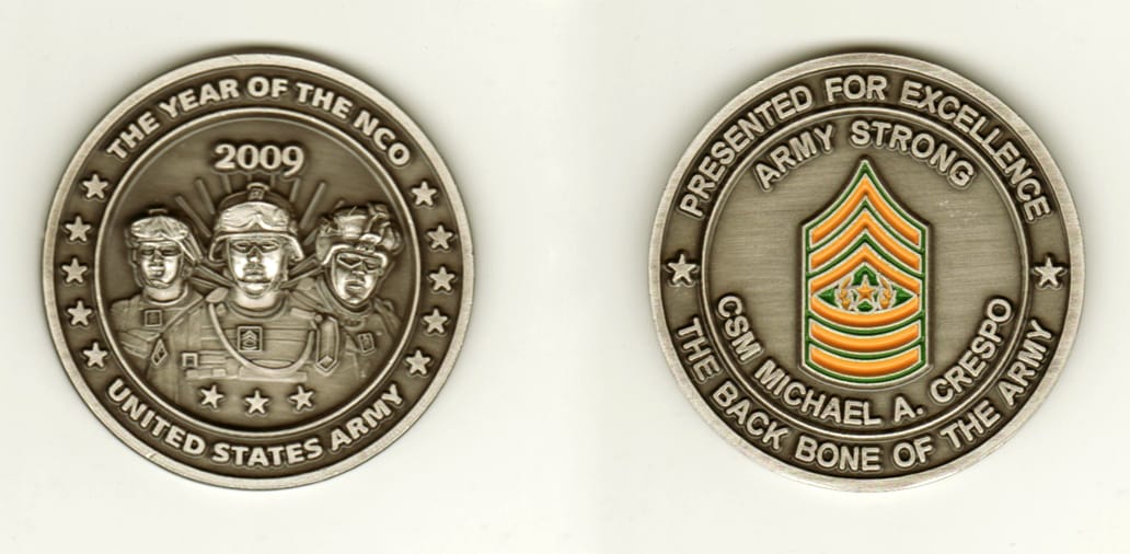 Round shaped, pewter colored coin, 2 1/8 inches in diameter.