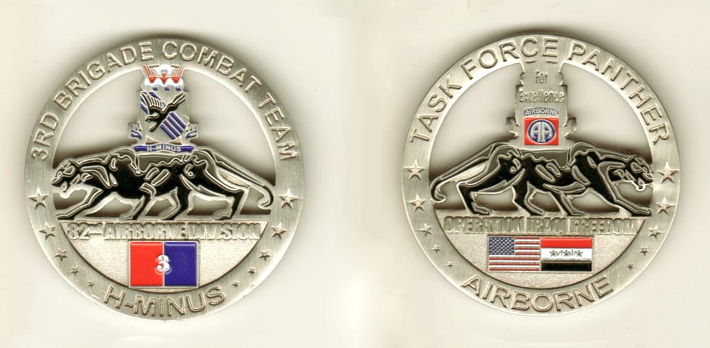 Round shaped, pewter colored coin, 2-1/8 inches in diameter.