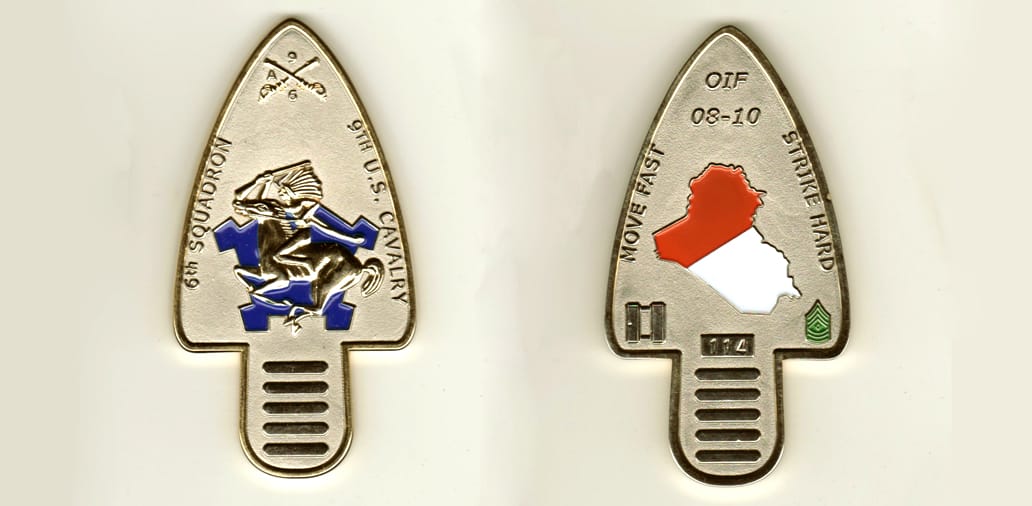 Arrowhead shaped, gold colored coin, 1 3/4 inches wide x 3 1/2 inches high.