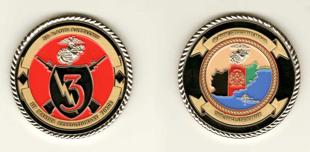 Round shaped, silver colored coin, 2 inches in diameter.