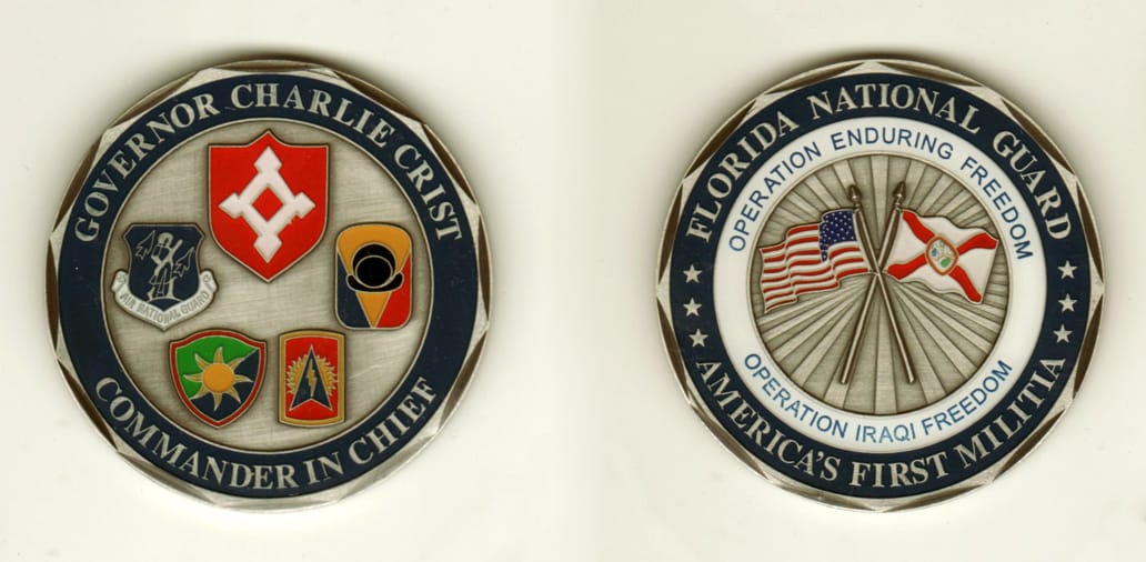 Round shaped, pewter colored coin, 2 inches in diameter.