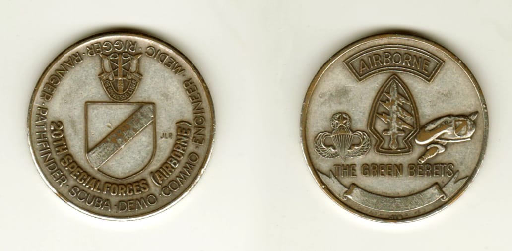 Round shaped, nickle colored coin, 1 1/4 inches in diameter.