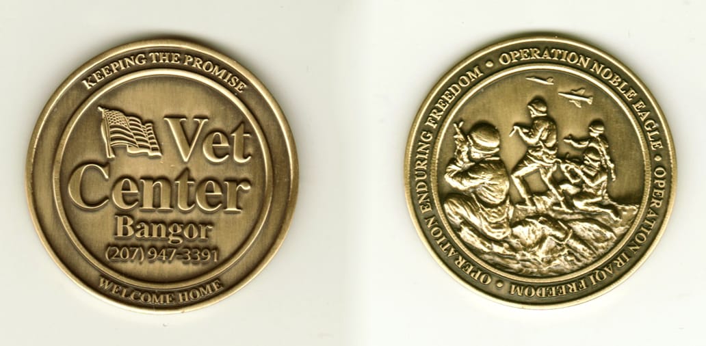 Round shaped, brass colored coin, 2 1/8 inches in diameter.