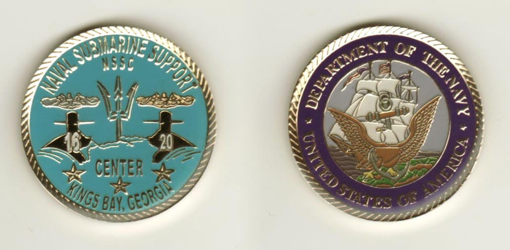 Round shaped, gold colored coin, 1 1/4 inches in diameter.