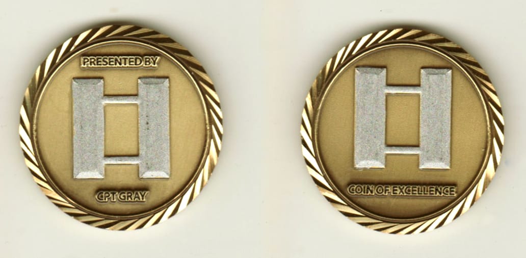 Round shaped, brass colored coin, 1 1/4 inches in diameter.