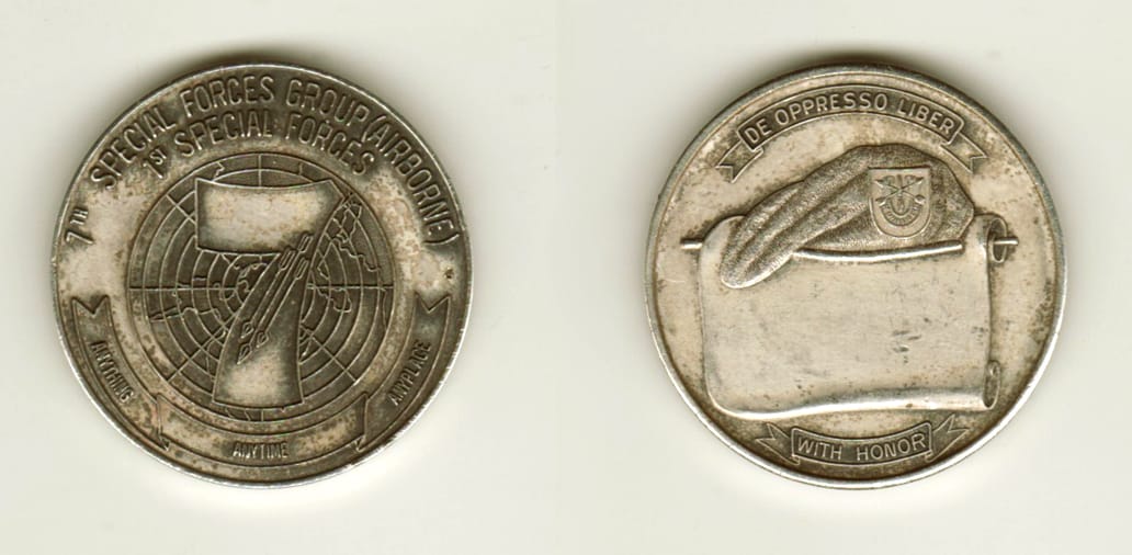 Round shaped, silver colored coin, 1 1/2 inches in diameter.